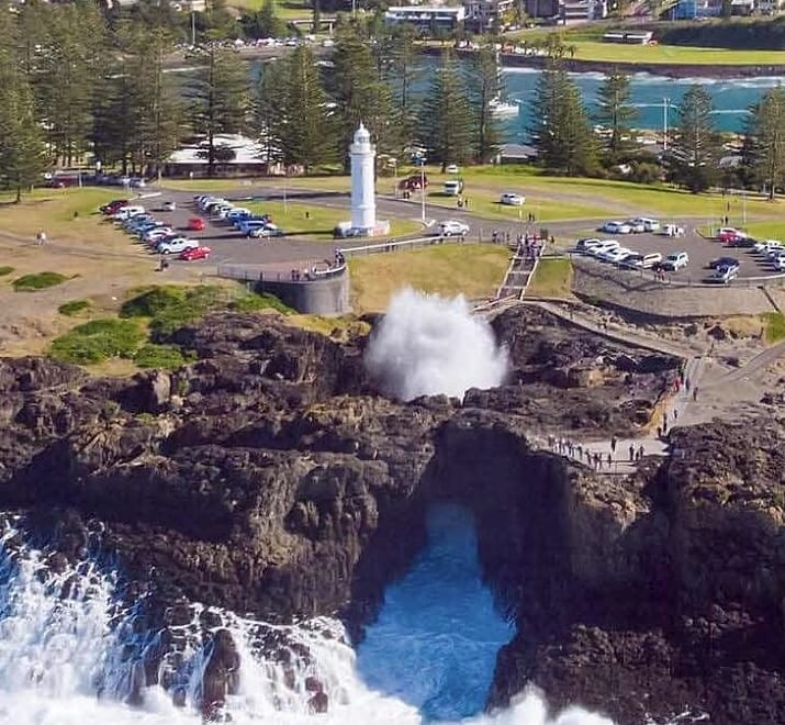 The Kiama Blowhole erupting below the lighthouse on Blowhole Point